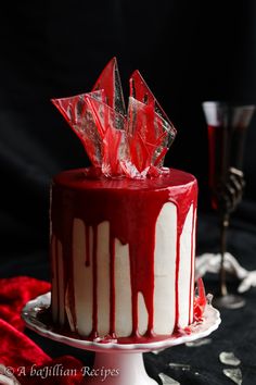 a red and white cake sitting on top of a table