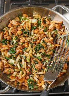 a skillet filled with stir fry vegetables and meat