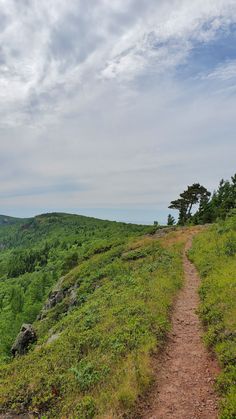 a dirt path going up the side of a hill