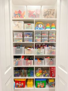 an organized closet with plastic bins and toys