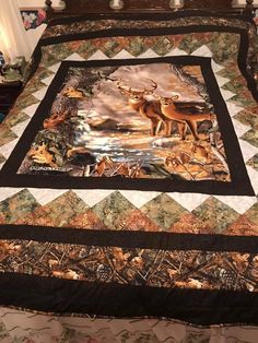 a bed covered in a quilt with deer on it