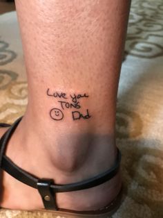 a woman's foot with the words love you tons and dad written on it