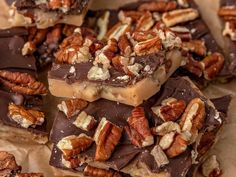 several pieces of pecan bar stacked on top of each other with chocolate and nuts