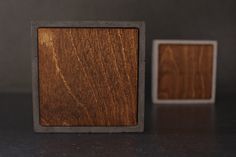 two square wooden objects sitting on top of a table