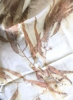 the fabric is covered with brown and white leaves on it's side, as if in an art nouveau manner