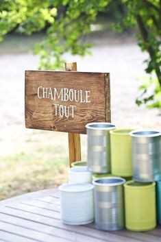 there is a sign that says chamboule tour next to many cans on the table