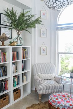 a living room filled with lots of furniture and bookshelves next to a window