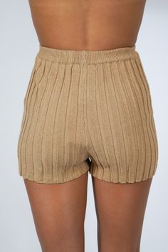 Get ready for summer with our Tiffany Ribbed Shorts! Made with a ribbed design, these pull on shorts are perfect for a comfy and stylish look. Pair them with our matching Tiffany Ribbed Top for a complete outfit. Say goodbye to boring shorts and hello to some serious fashion! Size + Fit Riley is 5'7" and wearing a size Small Content + Care 75% Acrylic 25% Nylon Hand Wash Cold Color Separate Ribbed Bottoms For Beach Summer, Solid Ribbed Bottoms For Summer, Trendy Ribbed Shorts, High Waist Ribbed Solid Shorts, Trendy Ribbed Shorts For Spring, Chic Ribbed Short Length Bottoms, Spring Ribbed Bottoms Short Length, Stretch Cotton Ribbed Shorts, Solid Summer Shorts With Ribbed Waistband