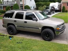 a silver suv parked in front of a house