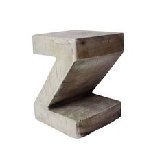 a wooden block with the letter z on it's side, against a white background