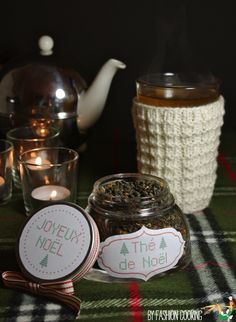 there is a tea pot and two cups on the table next to each other with labels in front of them