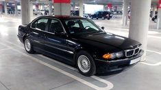 a black car parked in a parking garage