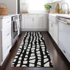 a black and white area rug in a kitchen