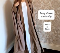 The perfect inner slip with long sleeves to style with any of our abayas. Each slip includes a belt too.  Material - soft touch Nidha (polyester)    Long sleeve - Black and half white. We also have a seperate listing for short sleeves.  https://www.etsy.com/listing/1352903192/abaya-slipunderslip-abaya-innerslip Please refer to the size guide in the images section.  No refunds/exchanges on this item. Long Abaya For Eid, White Long Sleeve Thobe For Formal Occasions, Formal White Long Sleeve Thobe, Modest Long Abaya For Eid, Fitted Long Thobe For Eid, Modest Long White Thobe, Elegant Fitted Long Sleeve Thobe, Elegant White Long Sleeve Abaya, White Formal Abaya For Eid