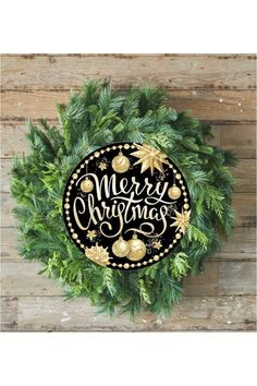 a merry christmas wreath on top of a wooden wall