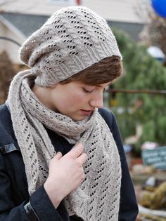 a woman wearing a knitted hat and scarf