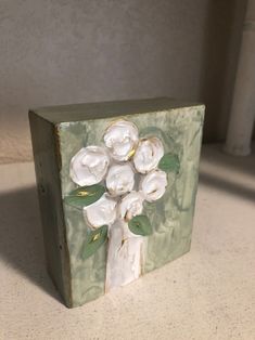 a small box with flowers painted on it