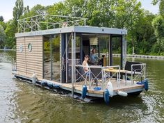 a house boat floating on top of a river