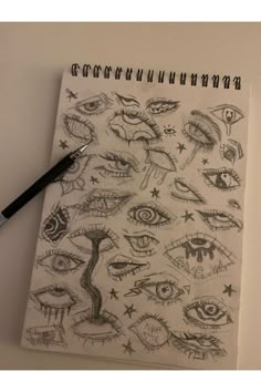 a spiral notebook with eye drawings on it