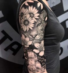 a woman's arm with a tiger and flowers on it