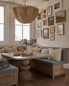 a living room filled with lots of furniture and pictures on the wall next to a window