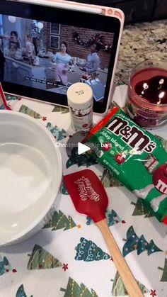 an image of food on the table with a laptop and tv in the back ground