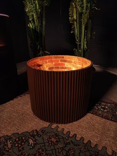 a planter made out of corrugated is sitting on the floor next to a rug