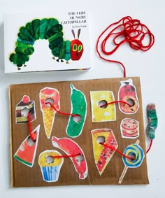 the very hungry caterpillar art project is made with construction paper, yarn and scissors