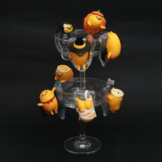 a wine glass filled with different types of figurines on top of each other