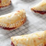 several small pastries are sitting on a cooling rack