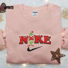 The Grinch Xmas x Nike Embroidered Sweatshirt is the perfect blend of holiday cheer and sporty style. Made with high-quality materials, this sweatshirt features an eye-catching embroidered design inspired by Nike. Its cozy and comfortable fit ensures warmth during the winter season. It makes for the best Christmas gift idea, offering a unique and trendy option for your loved ones. Let the Grinch and Nike bring joy and style to your festive celebrations! Discover Comfort with Our Unisex Heavy Shi Nike Inspired, Grinch Santa, Embroidered Apparel, Sweatshirt Nike, Maroon Hoodie, Hoodie Material, The Grinch, Embroidered Sweatshirt, Nike Fashion