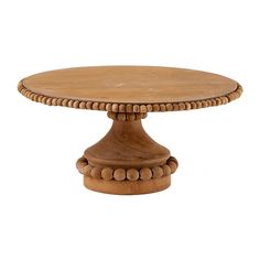 a round wooden table with beaded trim around the edges and top, on an isolated white background