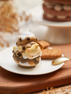 a chocolate cupcake decorated like a giraffe on top of a white plate