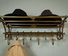 two hats are hanging on a coat rack