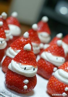 some strawberries with santa hats on them