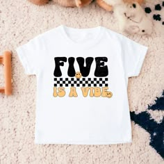 a white t - shirt with the words five is a vibe printed on it next to stuffed animals