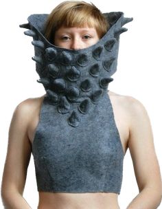 a woman wearing a gray top with an animal mask on her face and neck,