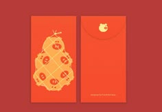 an orange card with a frog on it's front and back side, sitting next to a red envelope