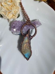 This crystal creation from Prairie House of Boho is a copper electroformed unpolished labradorite necklace. When this gemstone is in the right light, it flashes some fabulous multi-color tones! When this gemstone isn't in the limelight, it has a very earthy vibe. The copper surrounding the unpolished labradorite has been antiqued to highlight the texture that occurred during the electroforming process.  This unique necklace would be an amazing unisex gift for anyone who is a crystal lover! It wa Electroformed Labradorite Necklaces For Healing, Spiritual Style Copper Jewelry With Raw Stone, Spiritual Bronze Labradorite Necklace, Mystical Electroformed Moonstone Jewelry, Mystical Hand Forged Copper Necklaces, Mystical Hand Forged Labradorite Necklace, Mystical Hand Forged Copper Necklace, Mystical Pendant Necklace, Copper Electroformed Jewelry