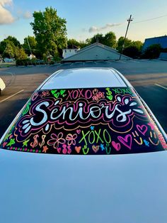 a car that has some stickers on the top of it's hood and is parked in a parking lot