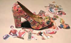 a pair of high heeled shoes sitting on top of a pile of stickers