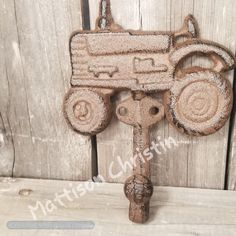 an old rusted metal toy truck hook on a wooden door with the word love written on it