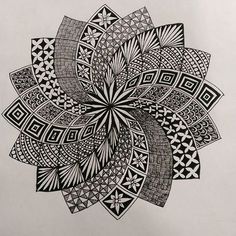 a black and white drawing of a flower with intricate designs on it's petals