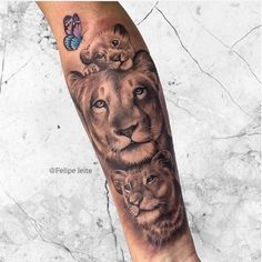 a lion and two cubs tattoo on the arm