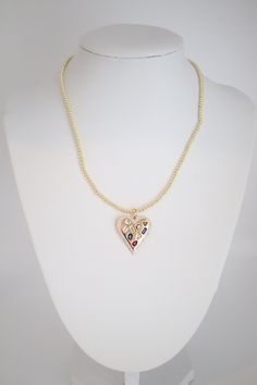 A Gold Beaded Necklace with Heart Pendant combines timeless elegance with a touch of romance, featuring a string of gold beads leading to a heart-shaped pendant. This accessory adds a sweet and sophisticated element to any outfit, making it a versatile and sentimental piece of jewelry. Gold Heart Beaded Necklace, Heart Shaped Beaded Chain Jewelry For Party, Heart-shaped Beaded Chain Jewelry For Party, Gold Beaded Heart Necklace Gift, Gold Heart-shaped Beaded Necklaces, Gold Beaded Heart Necklace For Gift, Gold Heart-shaped Beaded Necklace, Heart Pendant Beaded Necklace For Parties, Gold Heart Beads Necklace For Party