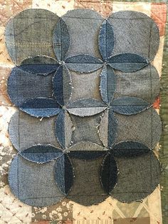 several pieces of fabric are arranged on top of each other with holes in the middle