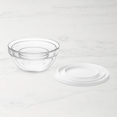 two clear bowls on a white marble surface