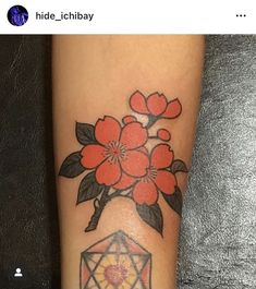 a tattoo with flowers and a diamond on it