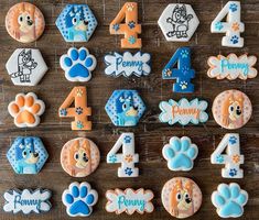 decorated cookies are arranged in the shape of animals and numbers for children's birthdays