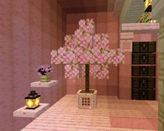 a tree in a room with pink and green decorations on the shelves next to it